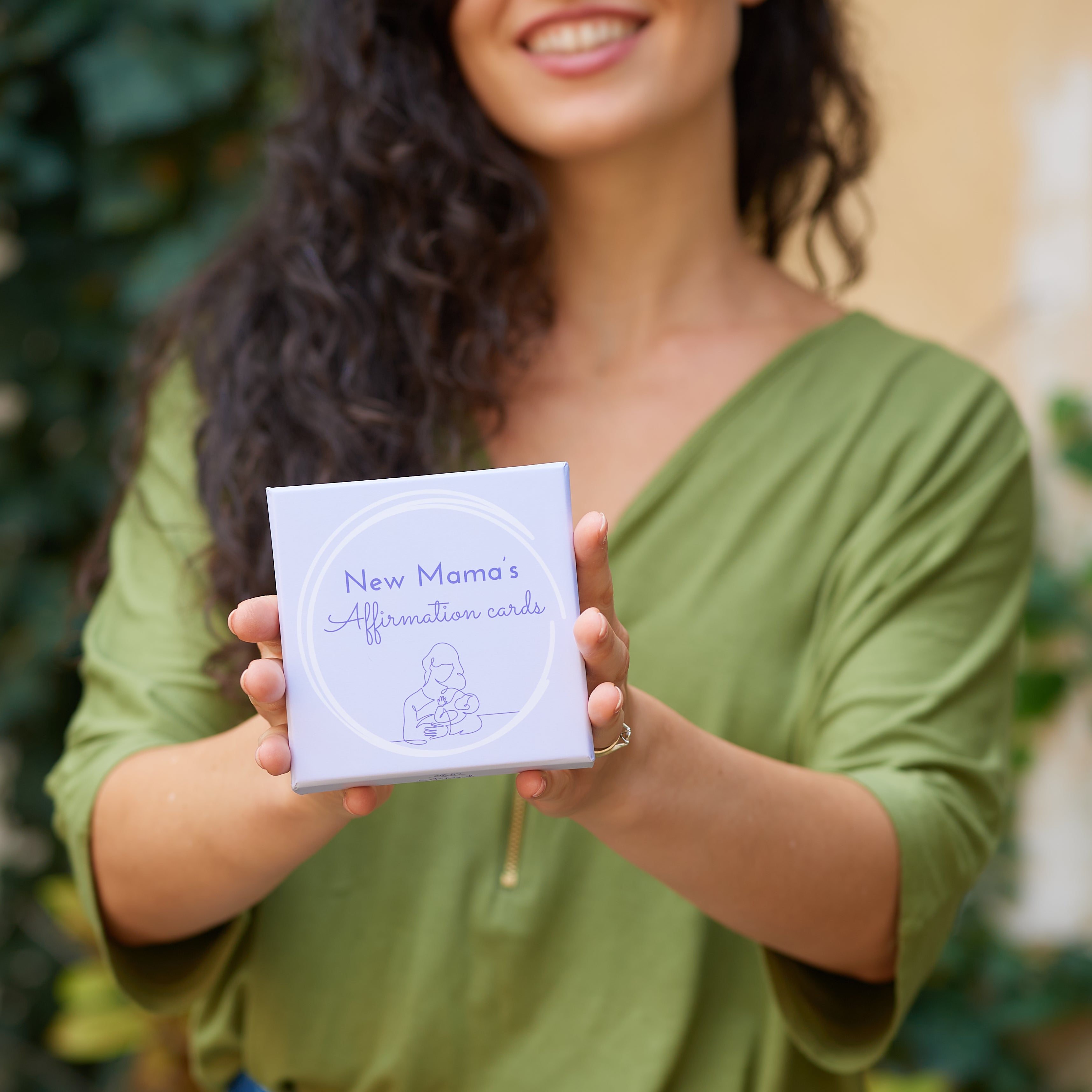 Woman holding new mama affirmation cards for ariond